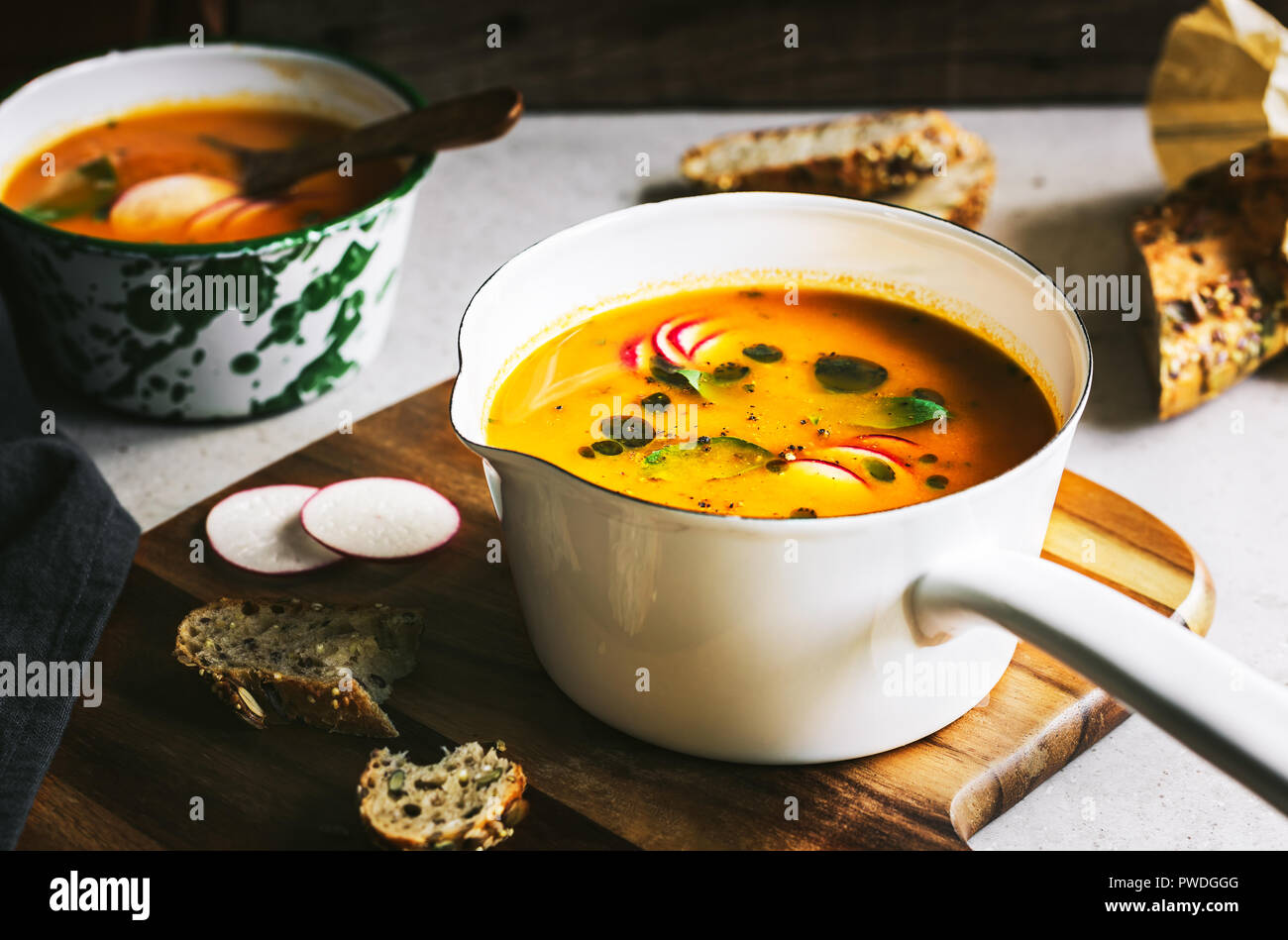 Carrot and Pumpkin soup with Basil oil by Multigrain seeds bread Stock Photo