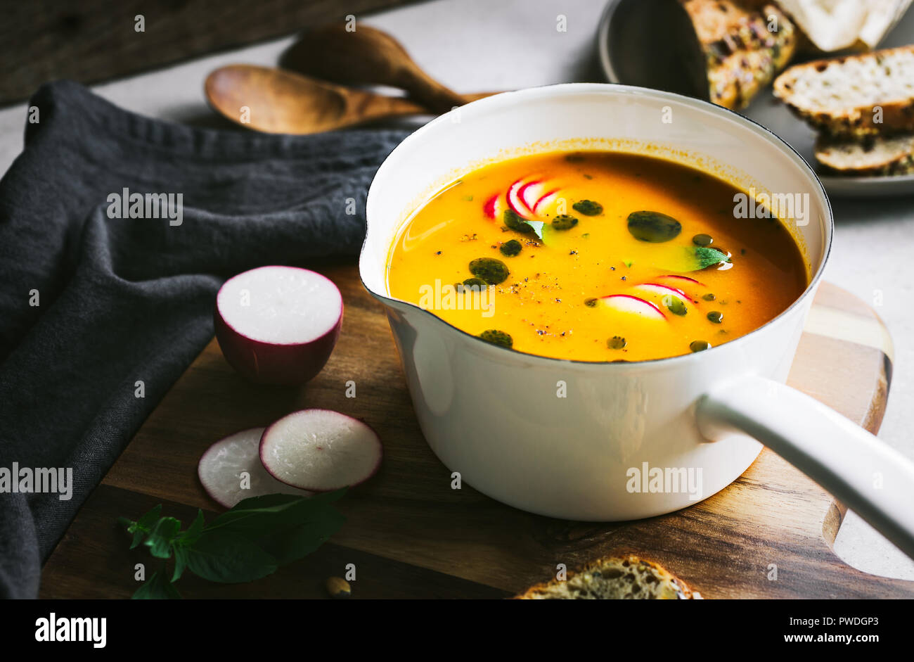 Carrot and Pumpkin soup with Basil oil by Multigrain seeds bread Stock Photo