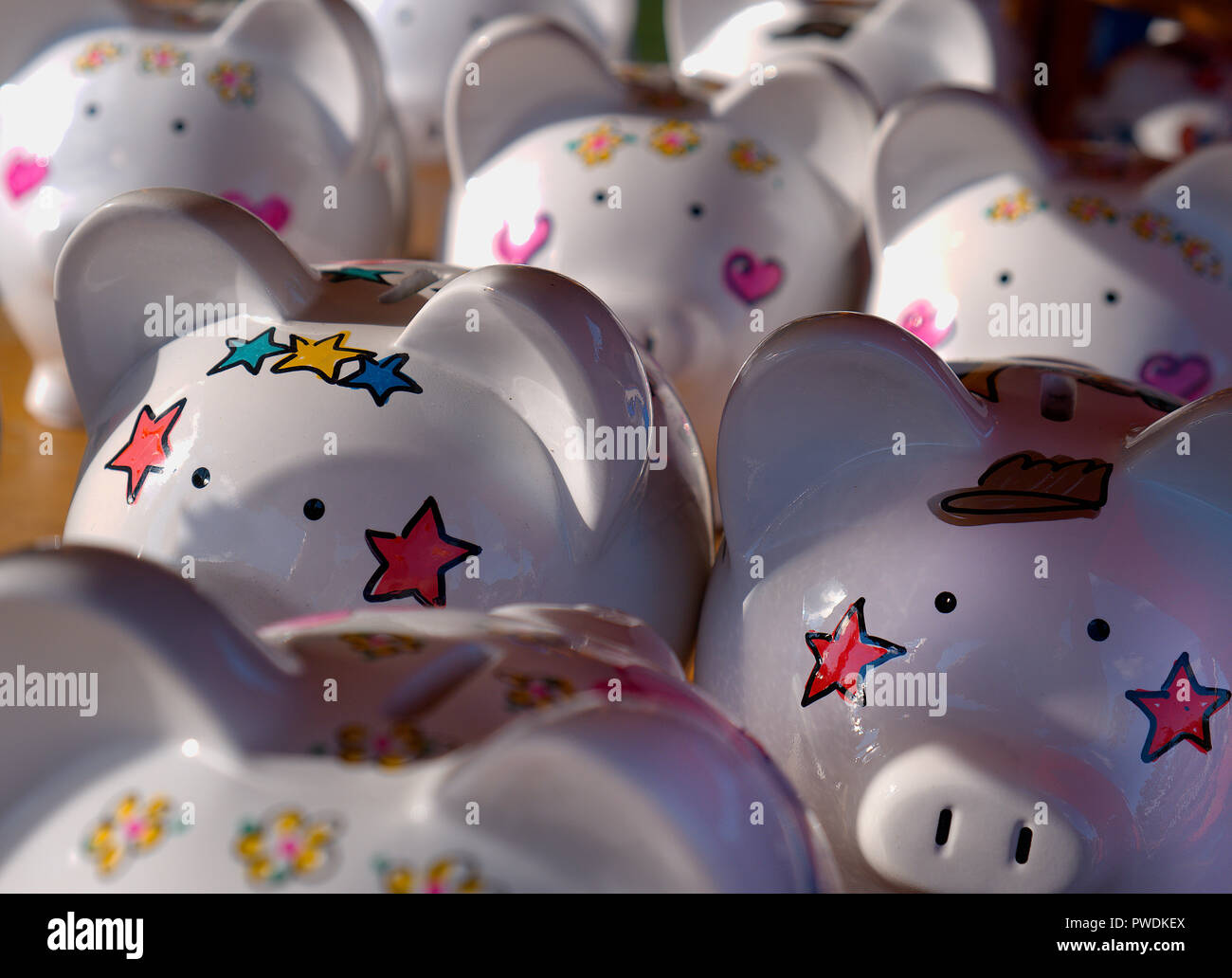 multiple decorated piggy banks in tight formation Stock Photo