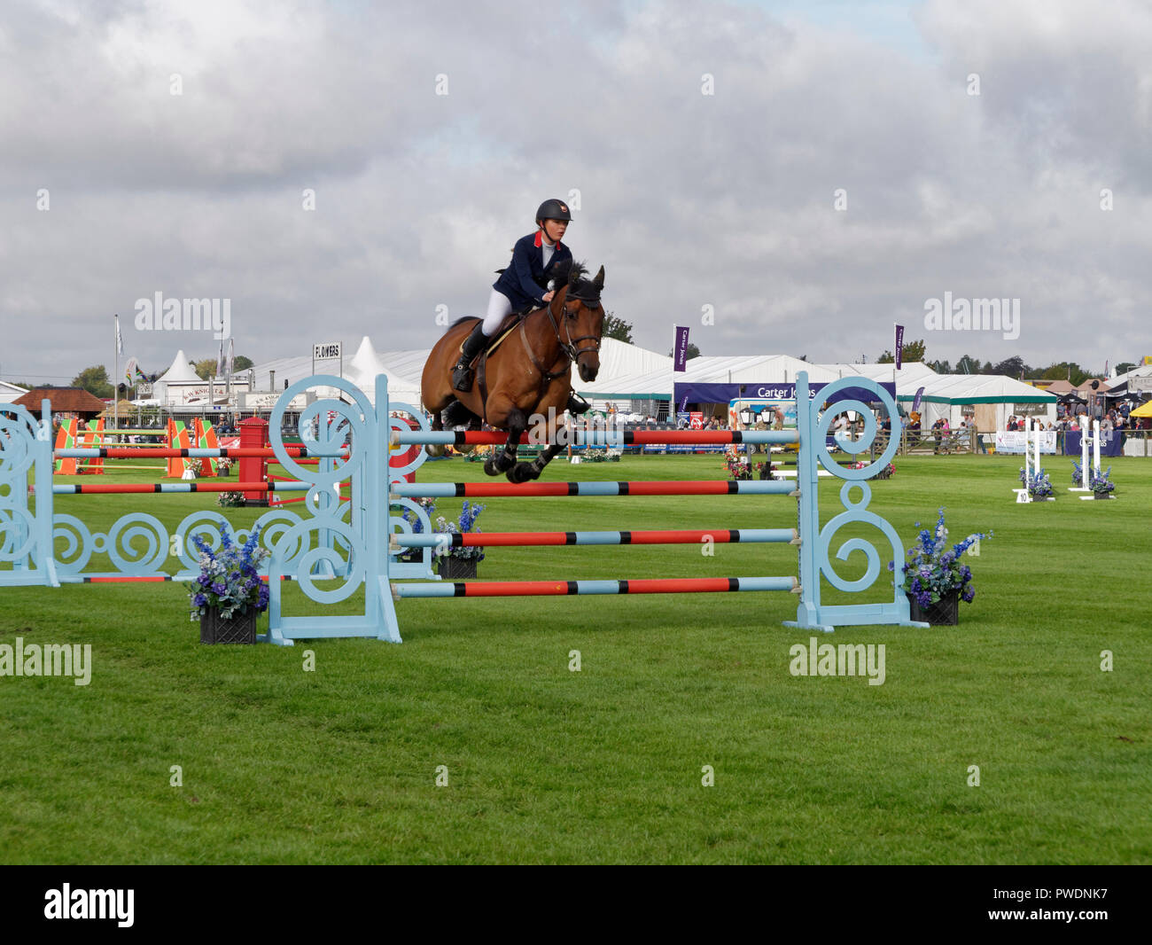 A show jumping competitor tackles one of the fences at the Berkshire County Show. The show is annual event held each September Stock Photo