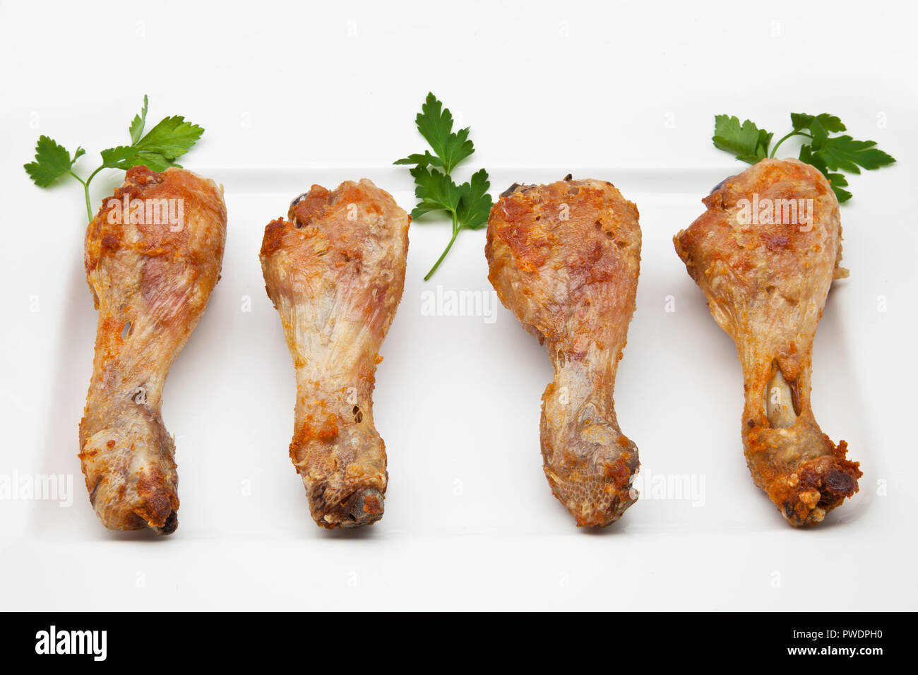 four fried chicken thighs ready to eat Stock Photo - Alamy