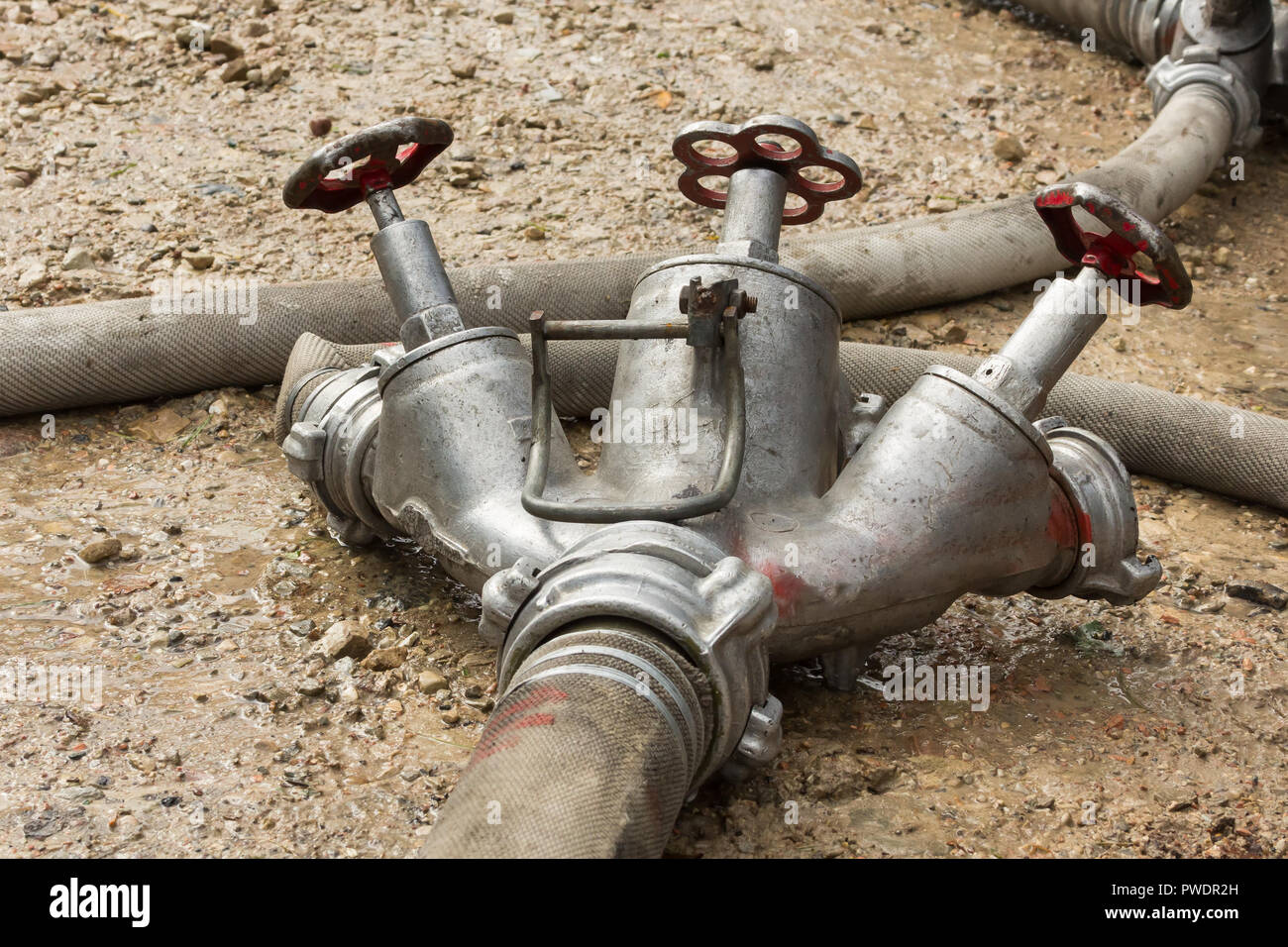 fire hose connection on the ground while extinguishing, accident background Stock Photo