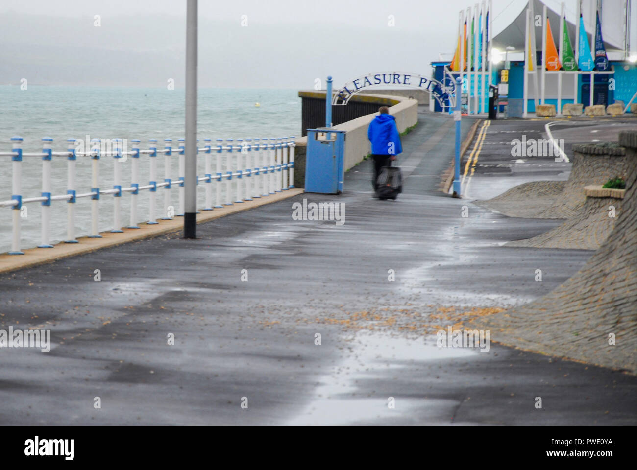 Weymouth. 15th October 2018. A man forlornly drags his suitcase along Credit: stuart fretwell/Alamy Live News Stock Photo