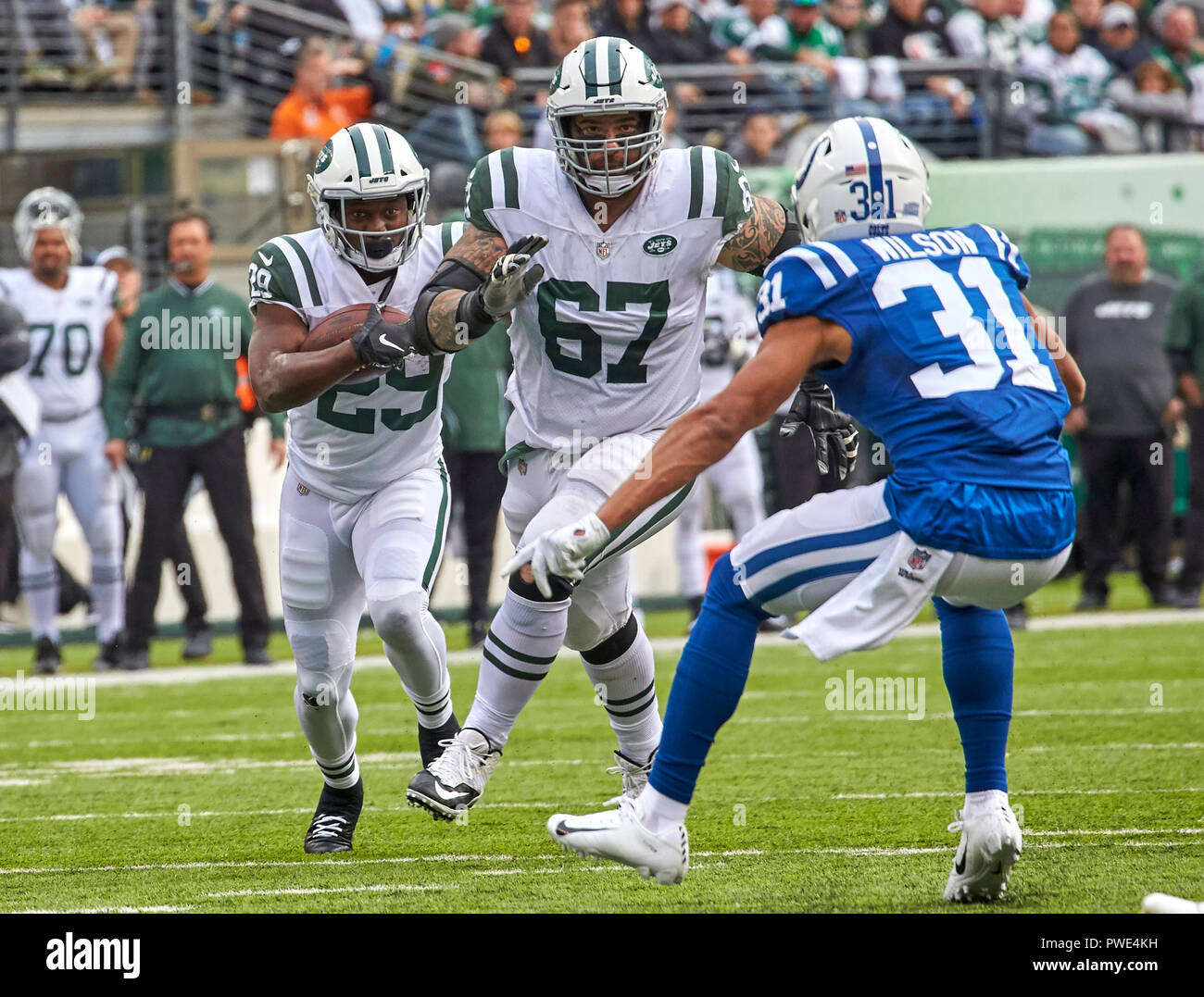 East Rutherford, New Jersey, USA. 14th Oct, 2018. New York Jets running  back Bilal Powell (29) follow s his blocker offensive guard Brian Winters  (67) against Indianapolis Colts cornerback Quincy Wilson (31)