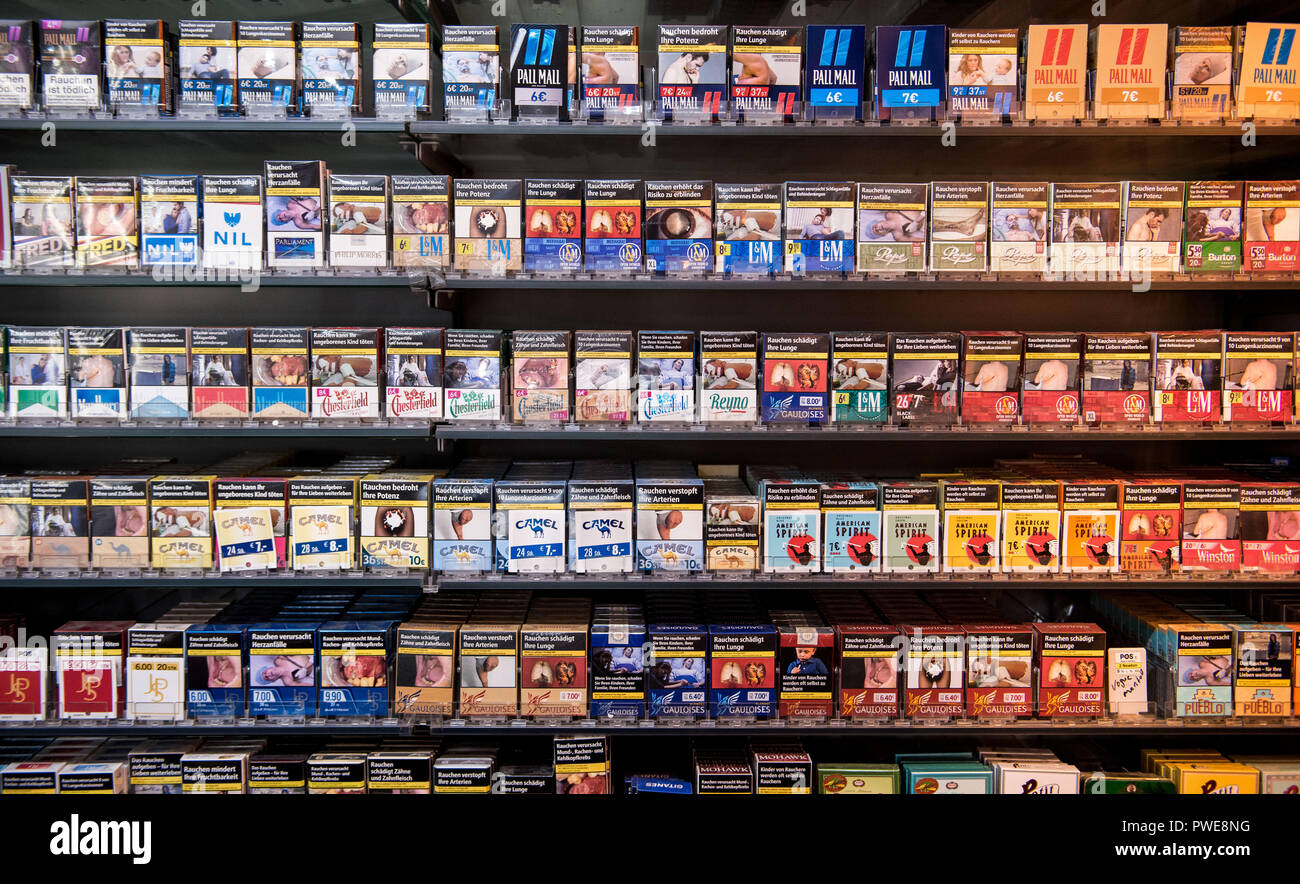 15 October 2018, Hamburg: Numerous cigarette packs are available in a kiosk on the shelf. In the third quarter, the production of tobacco products declined. According to the Federal Statistical Office, 19.78 billion cigarettes were taxed, about 3.6 percent less than in the same period last year. Photo: Daniel Bockwoldt/dpa Stock Photo