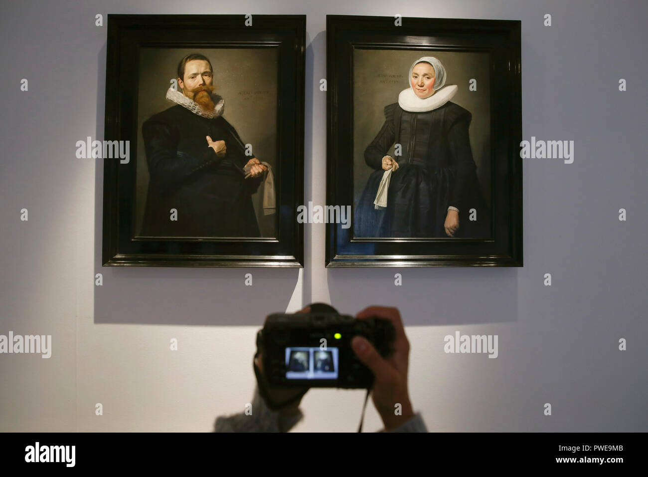 London, UK, 16th Oct 2018. A photographer captures Dutch master Frans Hals 's works 'Portrait of a Gentleman holding a pair of gloves' and ' Portrait of a lady holding a handkerchief' at Christie's AuctionHouse in London, UK, Tuesday October 16, 2017. The pair is expected to achieve up to £12million when they come to auction as part of the Albada Jelgersma Collection sale during Christie's Classic Week in December. Photograph : Credit: Luke MacGregor/Alamy Live News Stock Photo
