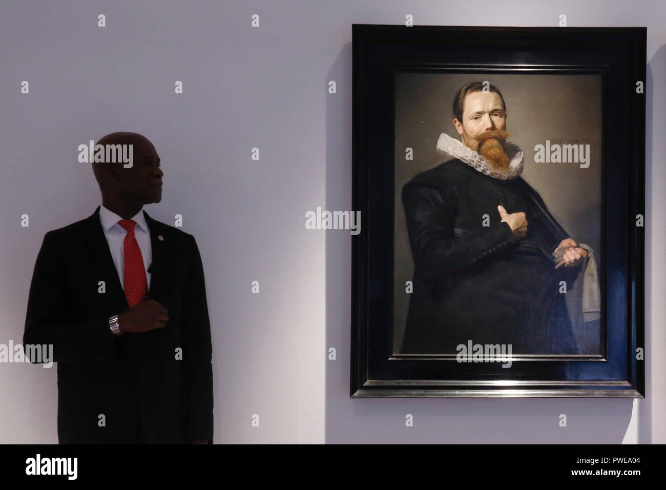 London, UK, 16th Oct 2018. A Christie's employee stands beside Dutch master Frans Hals 's works 'Portrait of a Gentleman holding a pair of gloves' at Christie's AuctionHouse in London, UK, Tuesday October 16, 2017. The pair is expected to achieve up to £12million when they come to auction as part of the Albada Jelgersma Collection sale during Christie's Classic Week in December. Photograph : Credit: Luke MacGregor/Alamy Live News Stock Photo