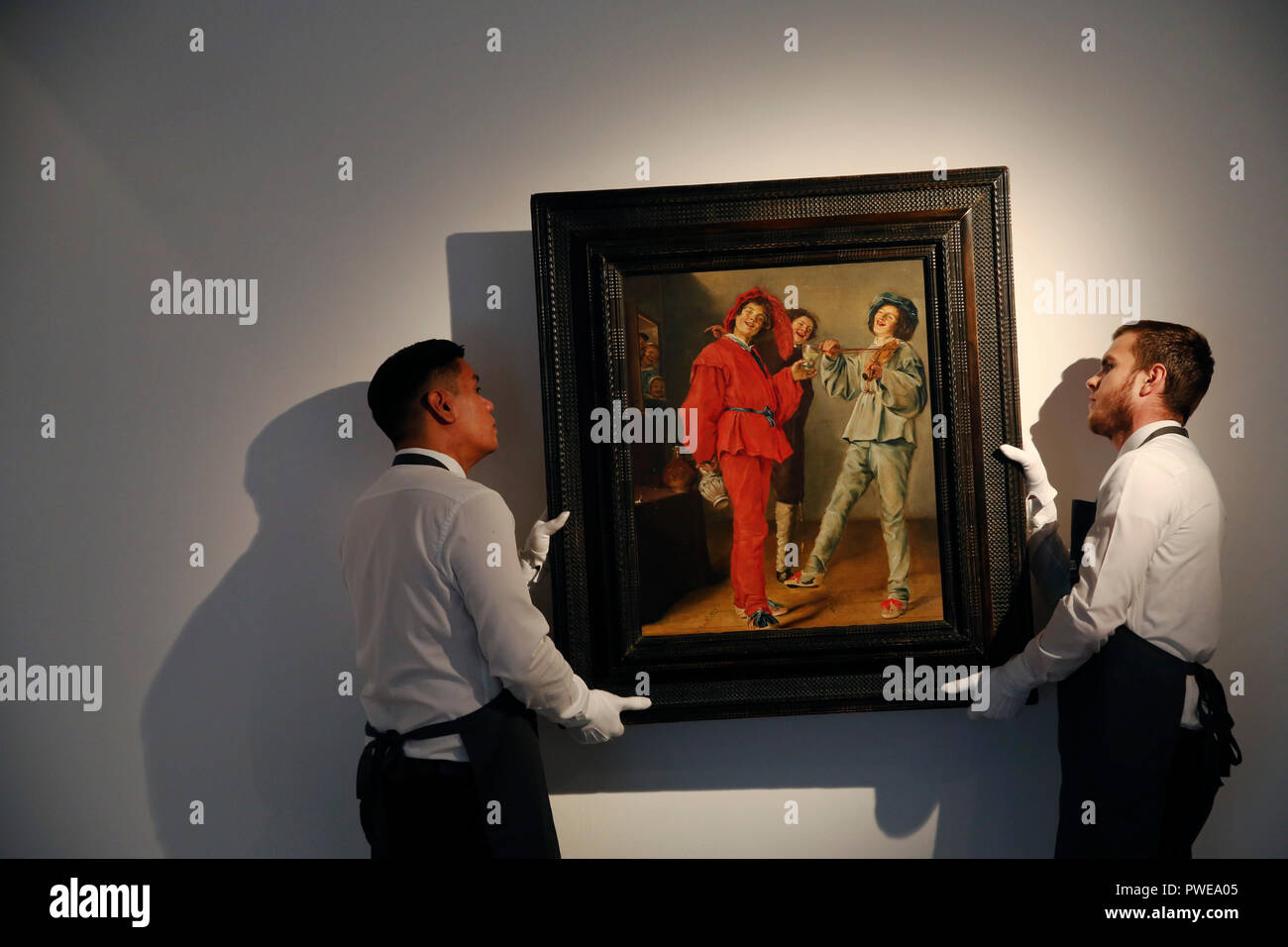 London, UK, 16th Oct 2018. Christie's art handlers hold Judith Leyster 's artwork 'Merry Company' at Christie's Auction House in London, UK, Tuesday October 16, 2017. The piece is expected to achieve up to £2.5million when is comes to auction as part of the Albada Jelgersma Collection sale during Christie's Classic Week in December. Photograph : Credit: Luke MacGregor/Alamy Live News Stock Photo