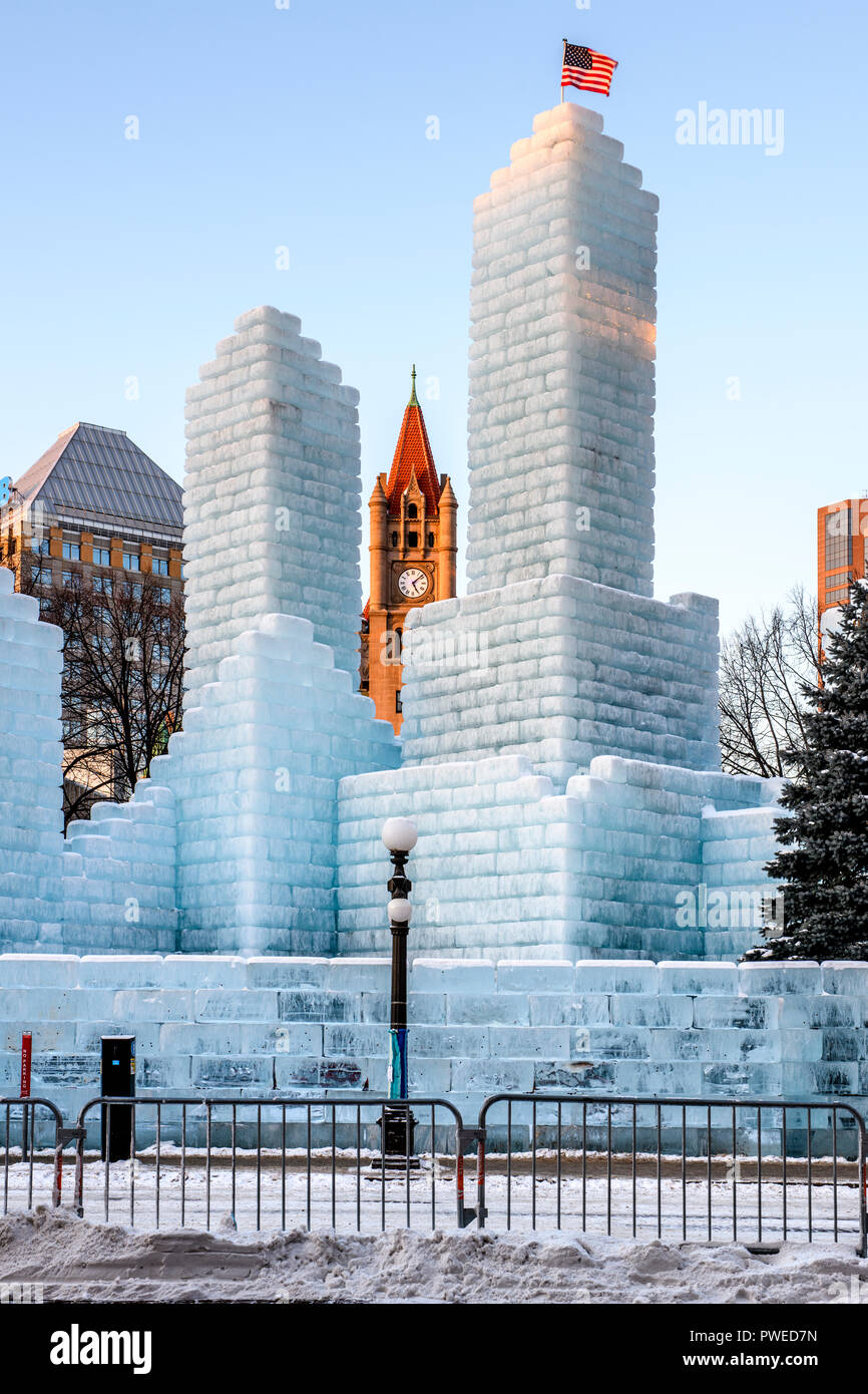 2018 Saint Paul Winter Carnival Ice Palace with Landmark Center clock tower. The ice palace was built in Rice Park downtown St. Paul, Minnesota. Stock Photo
