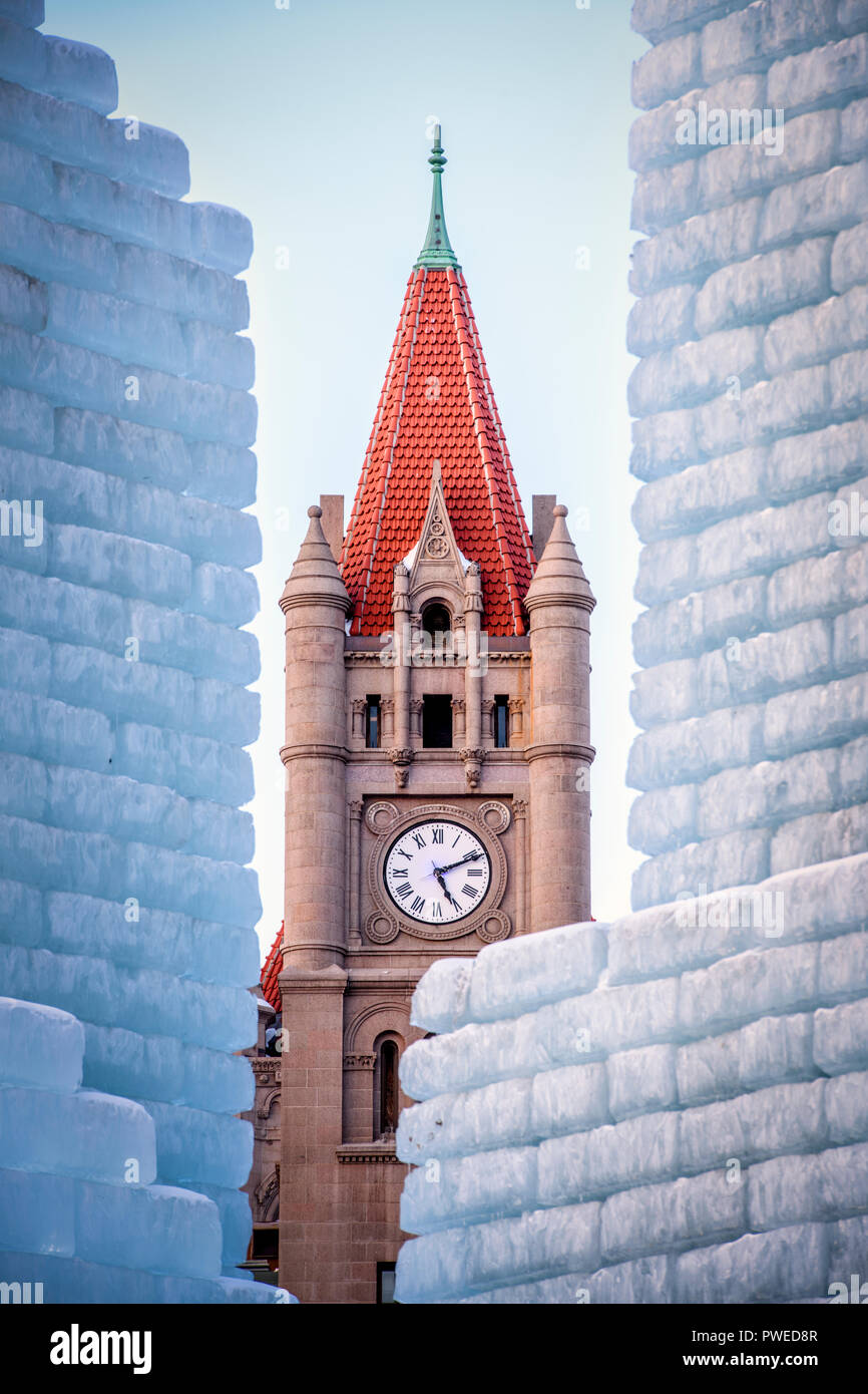 2018 Saint Paul Winter Carnival Ice Palace with Landmark Center clock tower. The ice palace was built in Rice Park downtown St. Paul, Minnesota. Stock Photo