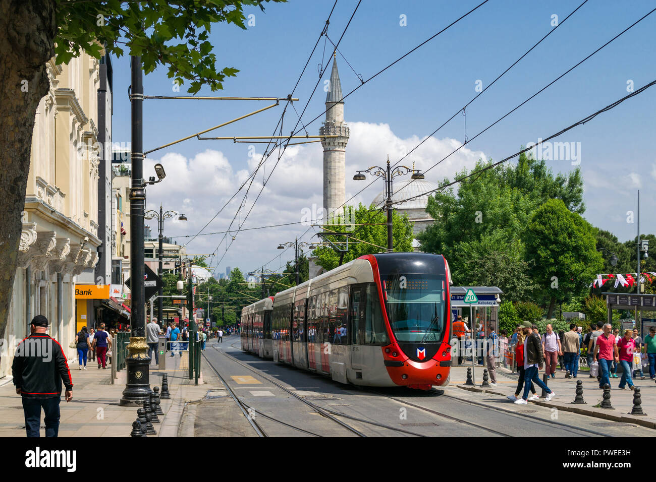 Sultanahmet tram station with tram at platform as people walk past, Istanbul, Turkey Stock Photo