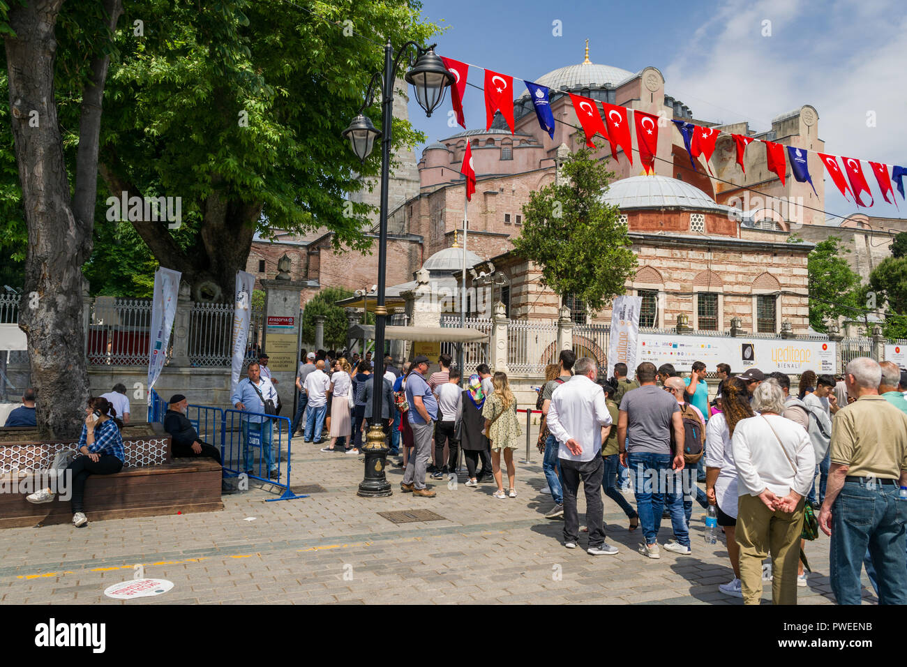 A long queue of tourists waiting to enter the Hagia Sophia museum on a sunny Spring day, Istanbul, Turkey Stock Photo