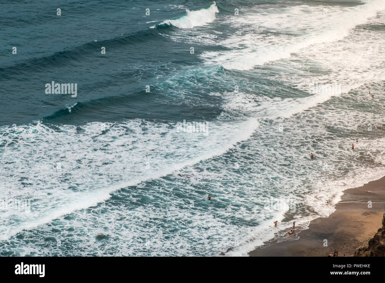beach aerial , people swimming in ocean waves - Stock Photo