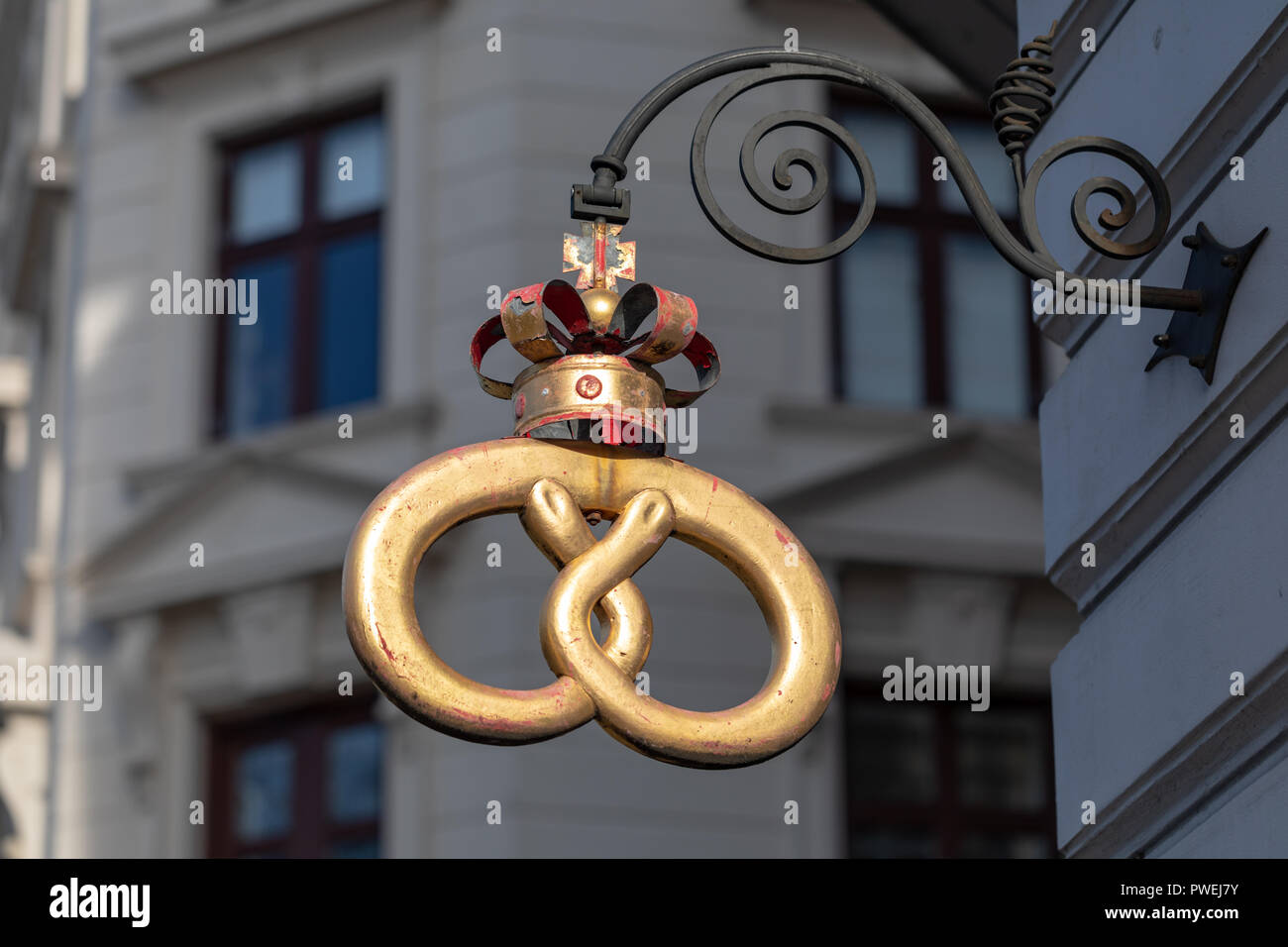 Traditional pretzel-shaped bakery sign, gold-coloured; Copenhagen, Denmark Stock Photo