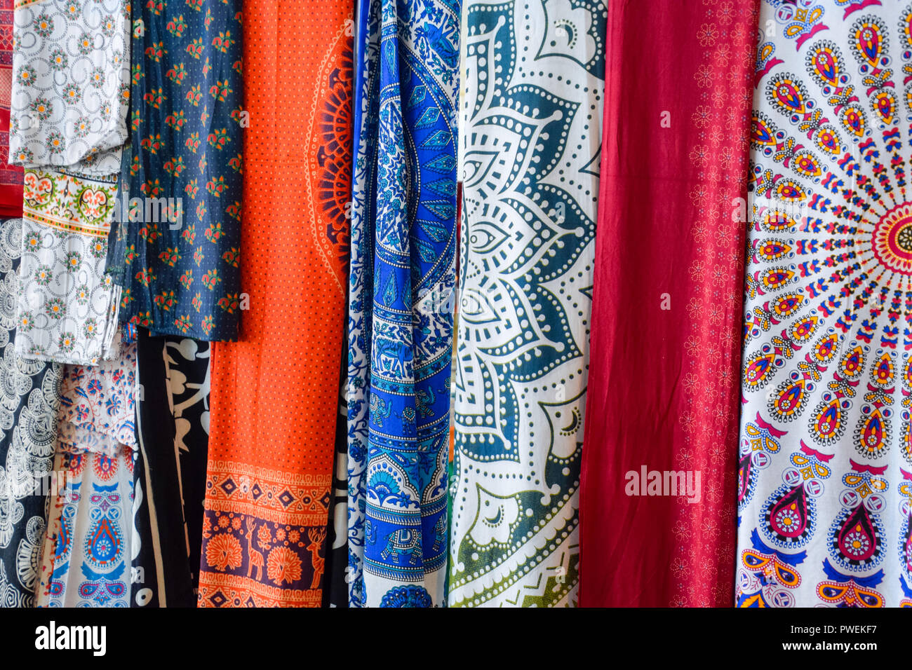 Indian fabrics hanging on the counter. Trade in fabrics from india
