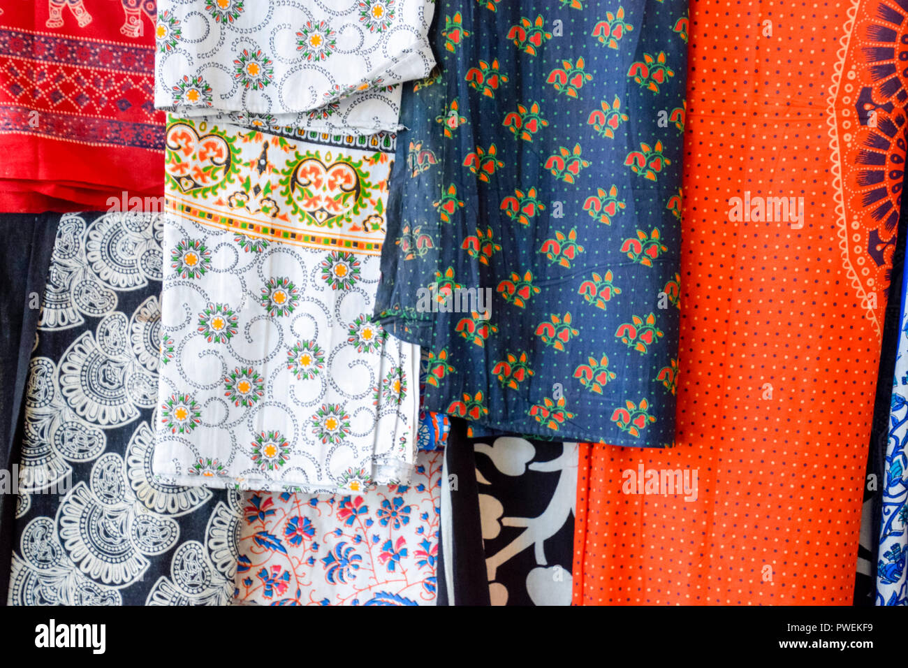Indian fabrics hanging on the counter. Trade in fabrics from india