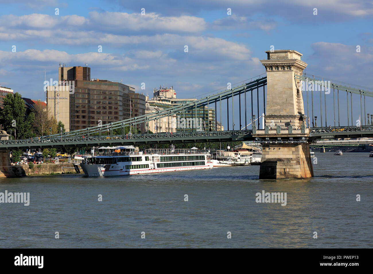 Hungary, Central Hungary, Budapest, Danube, Capital City, Hotel InterContinental and Marriott Hotel at the Danube bank of Pest, Chain Bridge between Pest and Buda, Istvan Szechenyi Bridge, Danube landscape, shipping pier, ships, Danube cruise, river navigation, UNESCO World Heritage Site Stock Photo