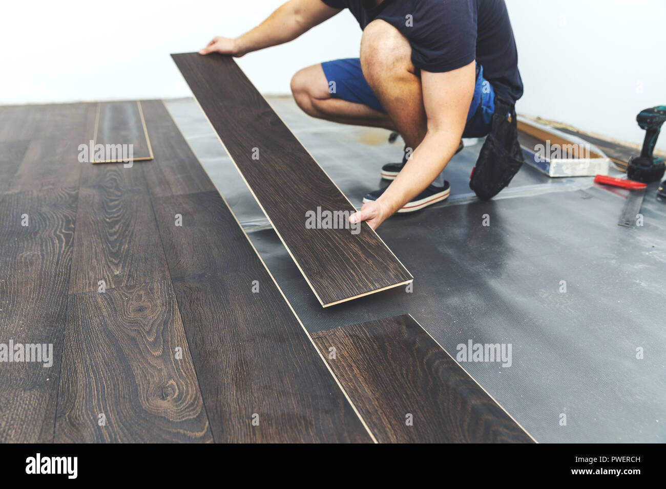 laminate flooring - worker installing new floor Stock Photo