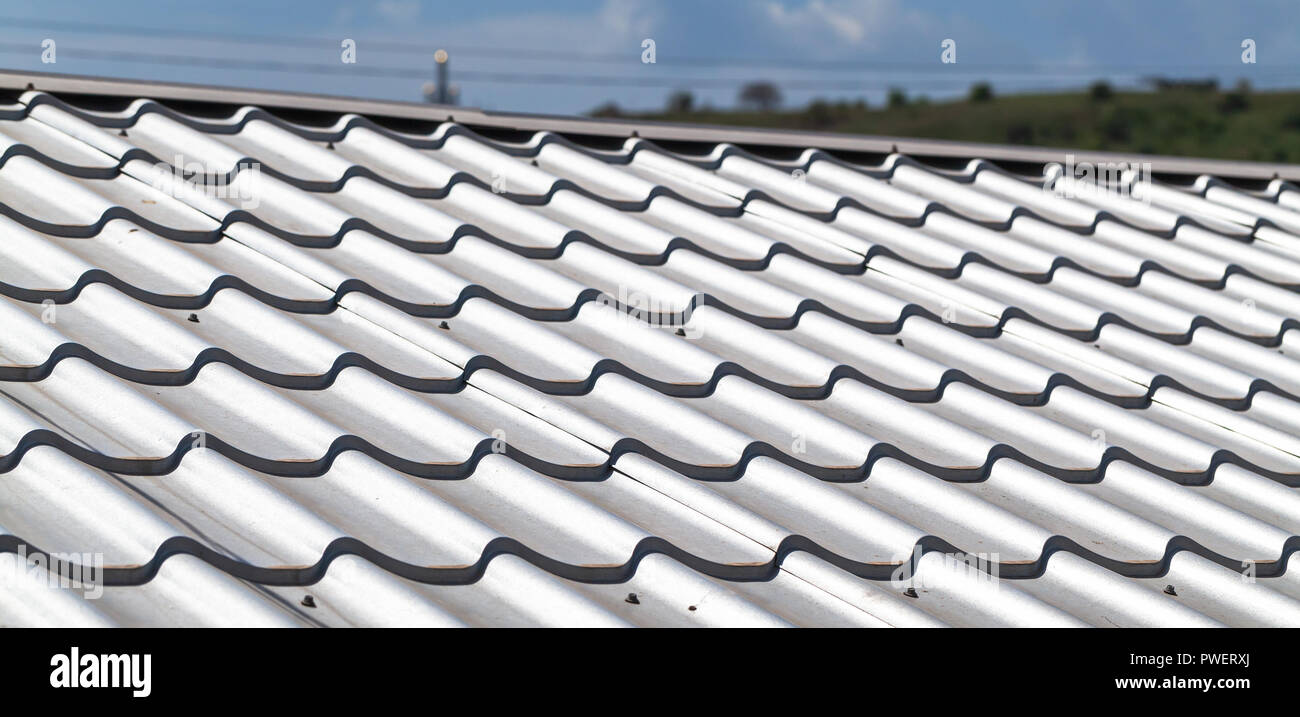 Light gray metal tile roofing, close-up background photo Stock Photo