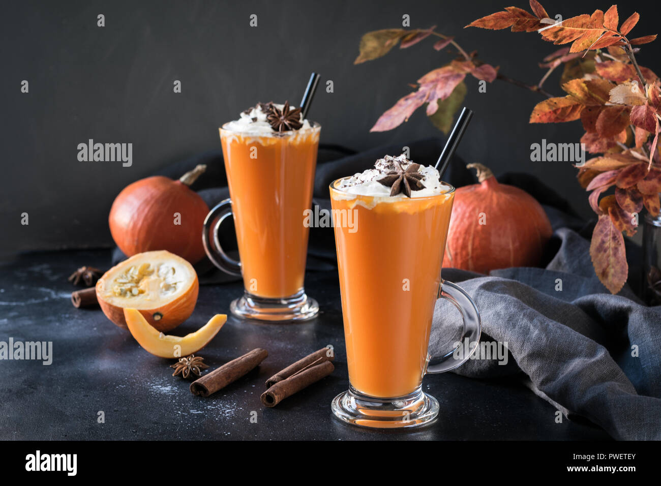 Fresh pumpkin smoothie or juice on dark. Autumn, fall or winter hot drink. Cozy healthy beverage. Stock Photo