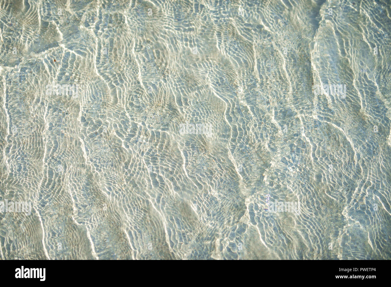 Clear tropical water background with small ripple texture and shallow ...
