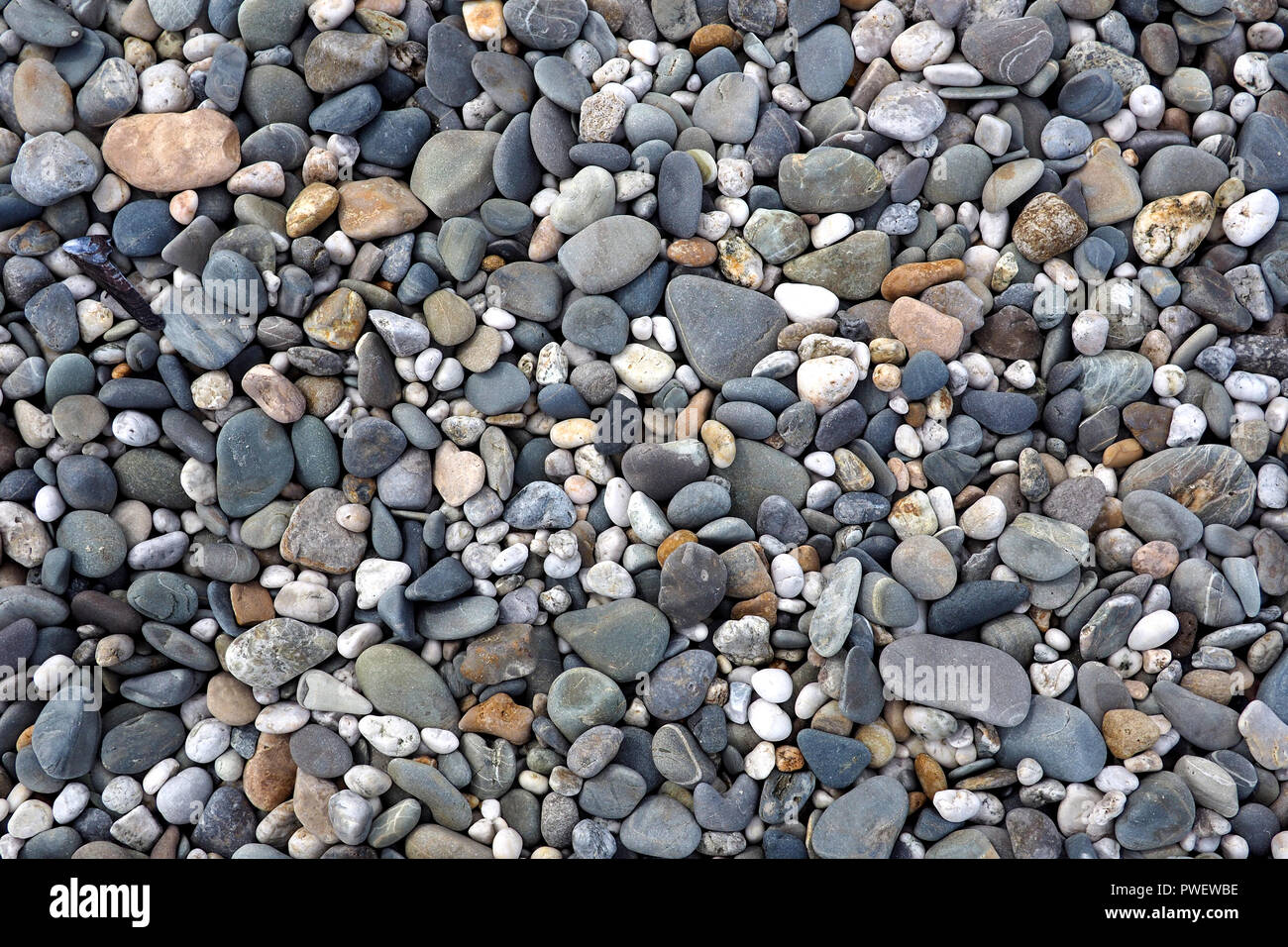 Textured pebbles on a beach Stock Photo - Alamy