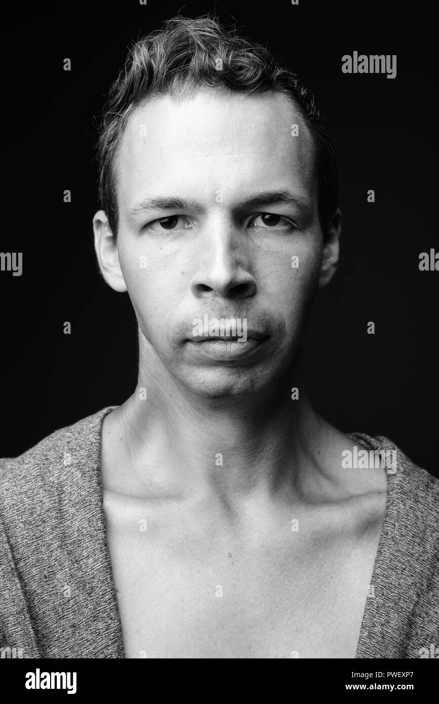 Rebellious man against black background in black and white Stock Photo