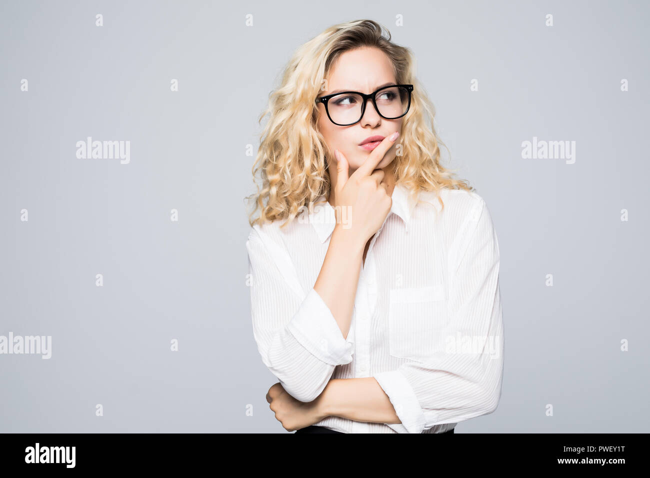Beautiful thinking business woman isolated white background Stock Photo