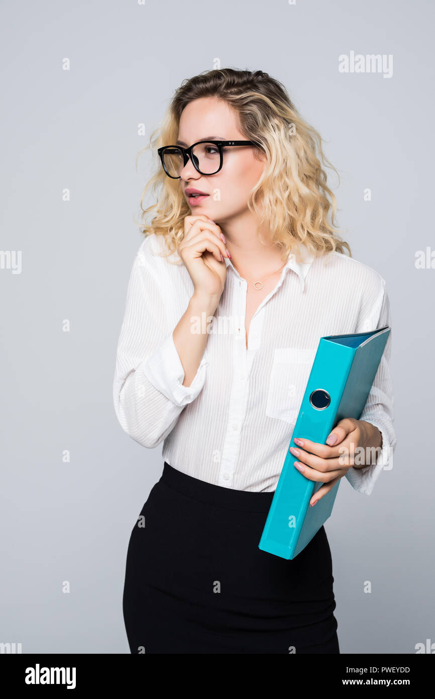 Portrait of young happy smiling business woman with blue folder ...