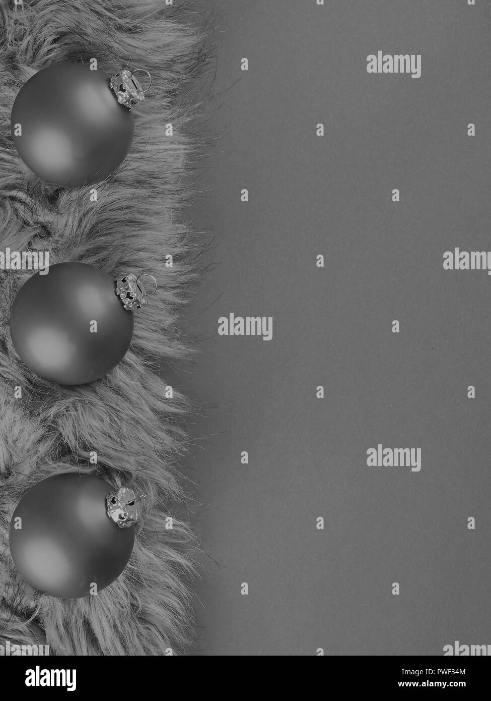 Christmas background from baubles on fur in monochrome Stock Photo