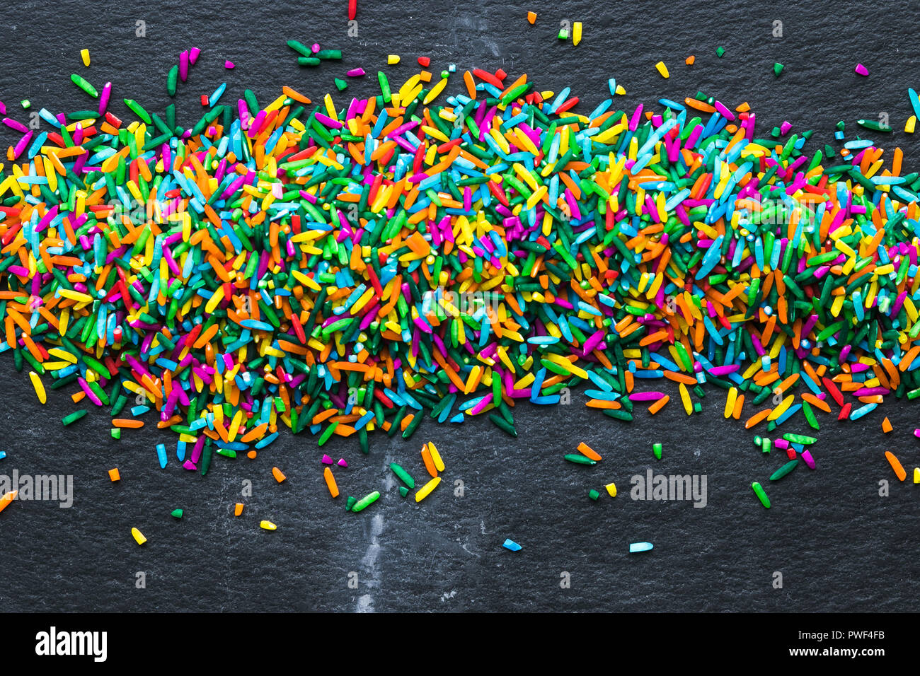 Copyspace on colorful rice grain on black background Stock Photo - Alamy