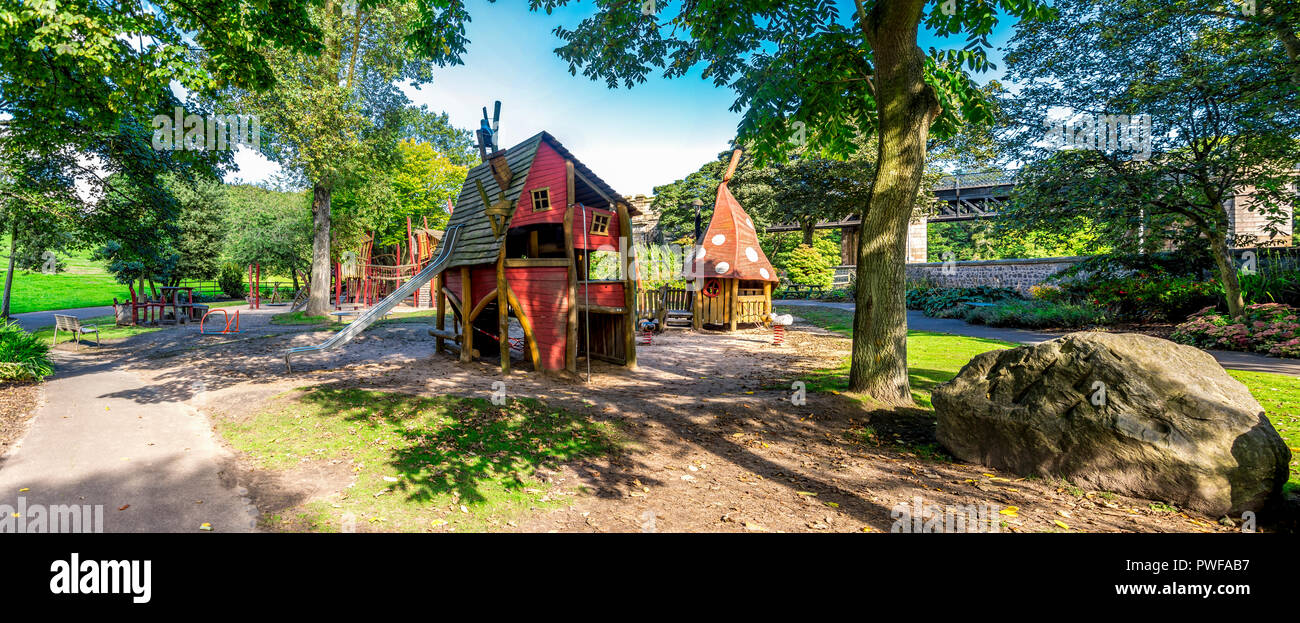 Panoramic view of wooden playground with magic houses and slide in Duthie park, Aberdeen, Scotland Stock Photo