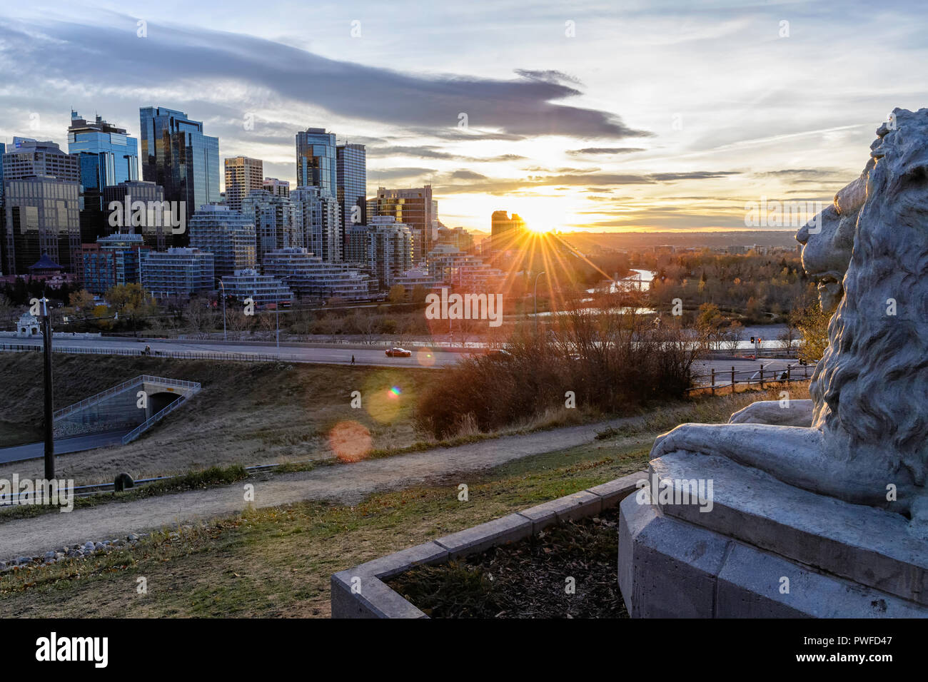An iconic Calgary lion sculpture now overlooks its old home on Centre Street Bridge installed in Rotary Park, Calgary skyline, Alberta Canada Stock Photo