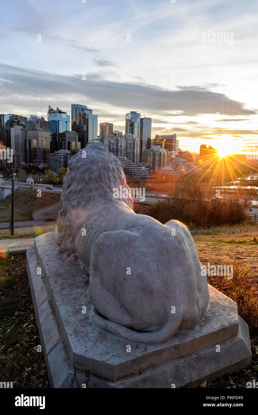 An iconic Calgary lion sculpture now overlooks its old home on Centre Street Bridge installed in Rotary Park, Calgary skyline, Alberta Canada Stock Photo