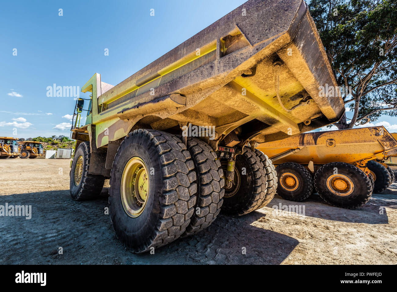 Enormous dirty green dumper truck in quarry site Stock Photo