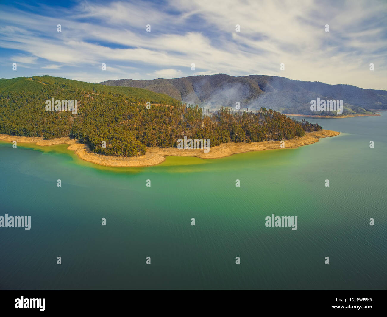 Aerial view of forest fire on shores of Blowering reservoir lake Stock ...