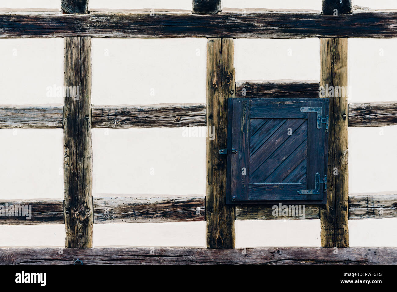 The wall of the old house with a window. Timber framing construction are traditional methods of
