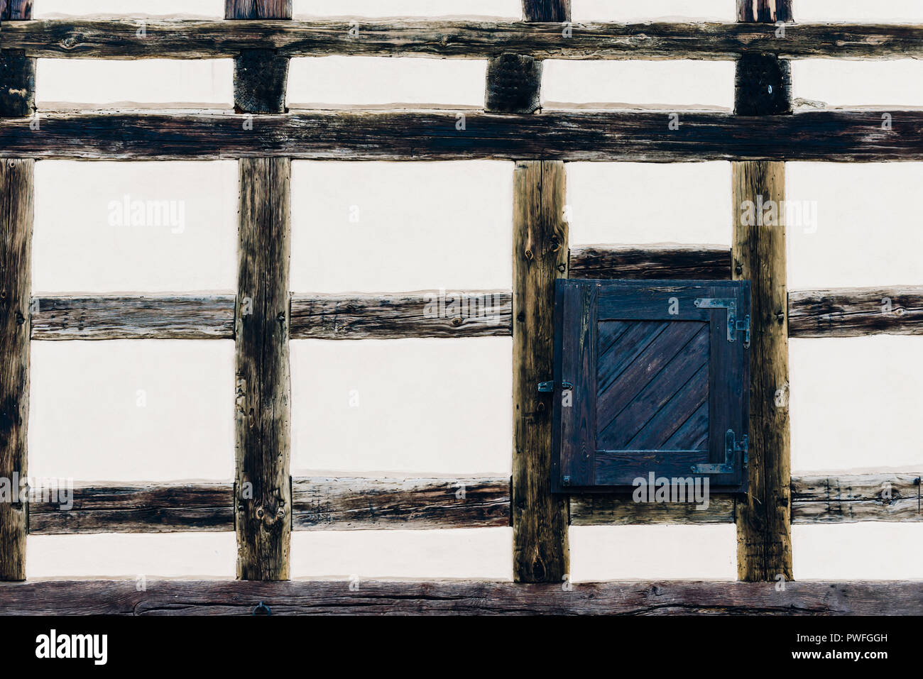The wall of the old house with a window. Timber framing construction are traditional methods of