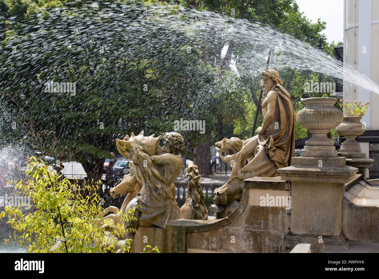 CHELTENHAM, GLOUCESTERSHIRE, ENGLAND - August 7, 2018: The Neptune fountain outside the Municipal offices, based on the Trevi Fountain in rome. Stock Photo