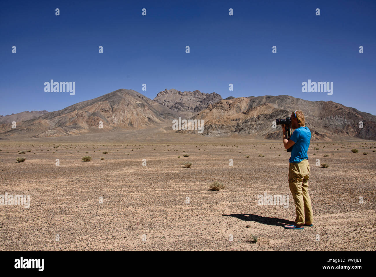 Photographer in the Pamir Highway near Murghab, Tajikistan Stock Photo