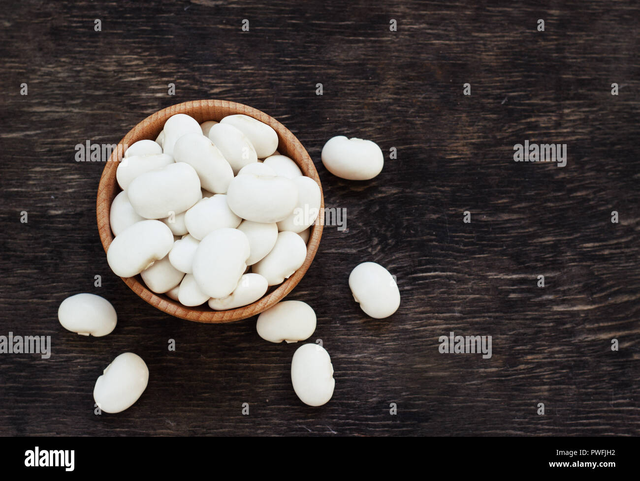 White navy beans in wooden bowl, also haricot, pearl haricot, boston