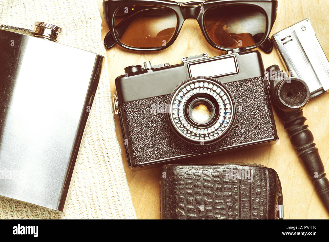 Accessories of the creative person. 35mm film camera, exposure meter in leather case, steel