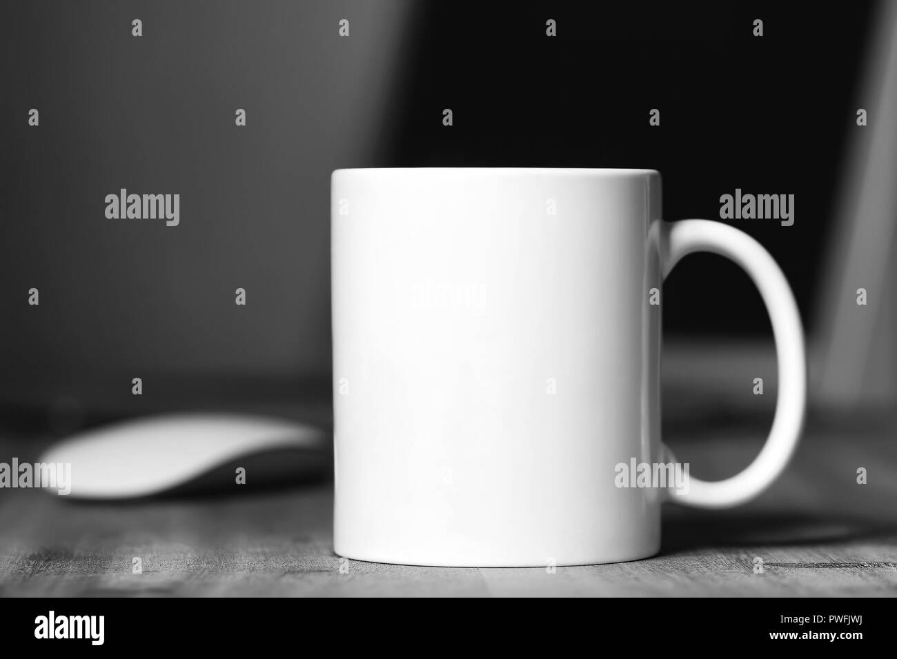 White mug on the wooden table. Office workspace background Stock Photo