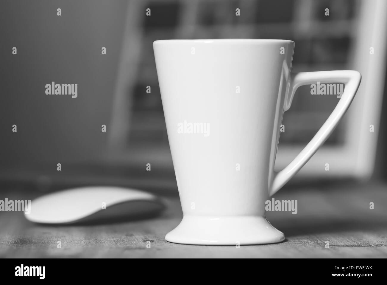 White mug on the wooden table. Office workspace background Stock Photo