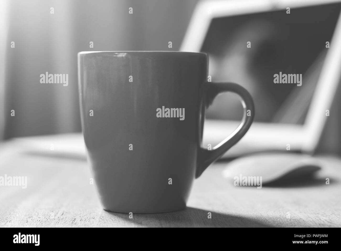 Grey mug on the wooden table. Office workspace background Stock Photo