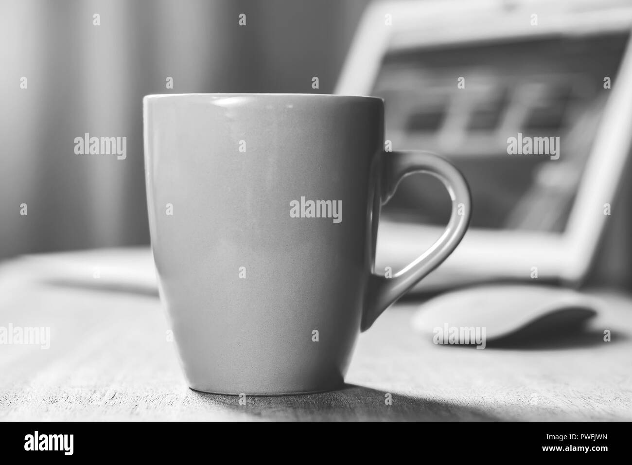Grey mug on the wooden table. Office workspace background Stock Photo