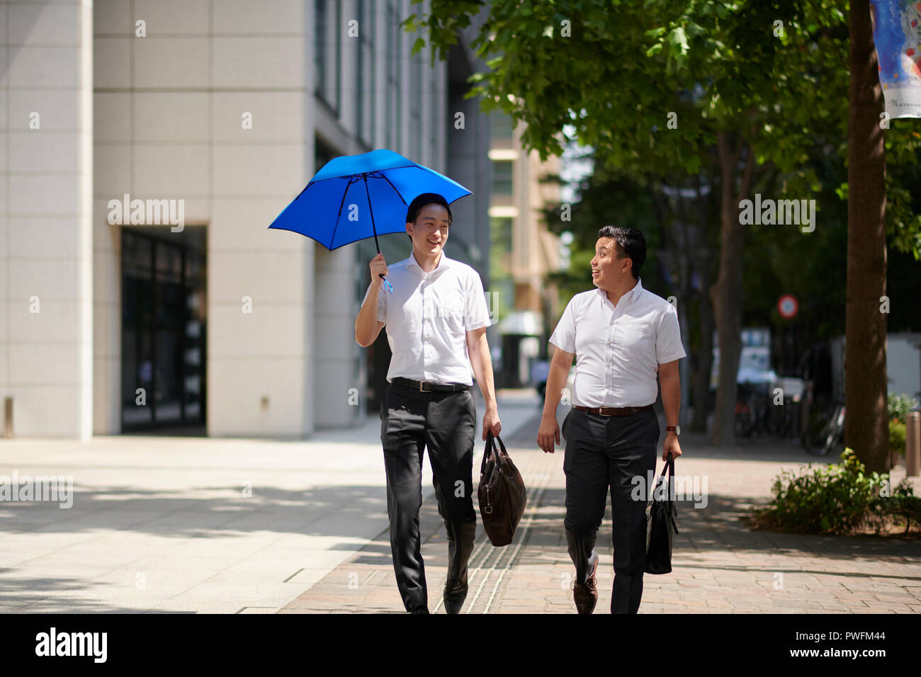 Japanese men with parasol Stock Photo - Alamy