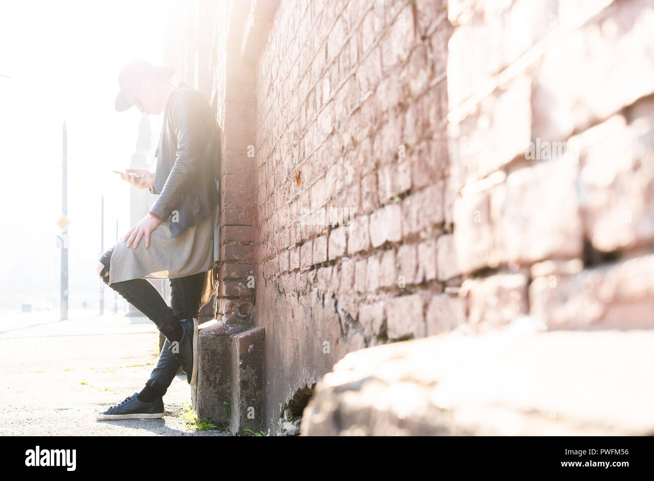 Young man posing with a trendy outfit against a urban background Stock ...