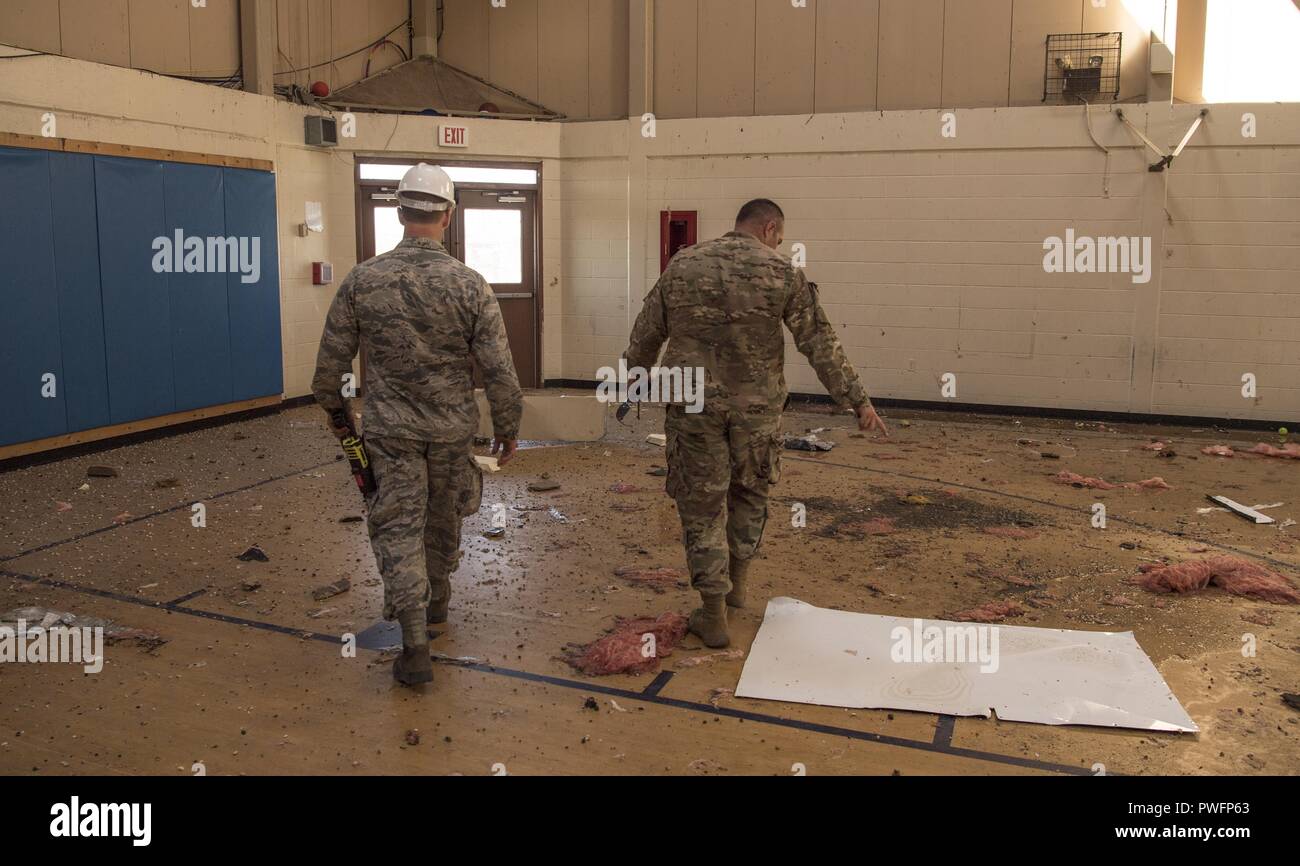 Civil engineers from the Tyndall Air Force Base's 325th Civil Engineer Squadron inspect the damage at the youth center of Tyndall Air Force Base, Florida, following the devastation caused by Hurricane Michael, Oct. 14, 2018, October 14, 2018. Air Combat Command has mobilized multiple squadrons across the major command to aid in the restoration of base functions following massive damages from high winds. (U.S. Air Force photo by Senior Airman Keifer Bowes). () Stock Photo