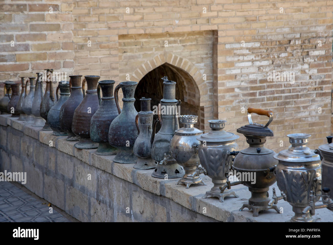 Old metal samovars and decanters on display in bazaar in Bukhara, Uzbekistan. Stock Photo